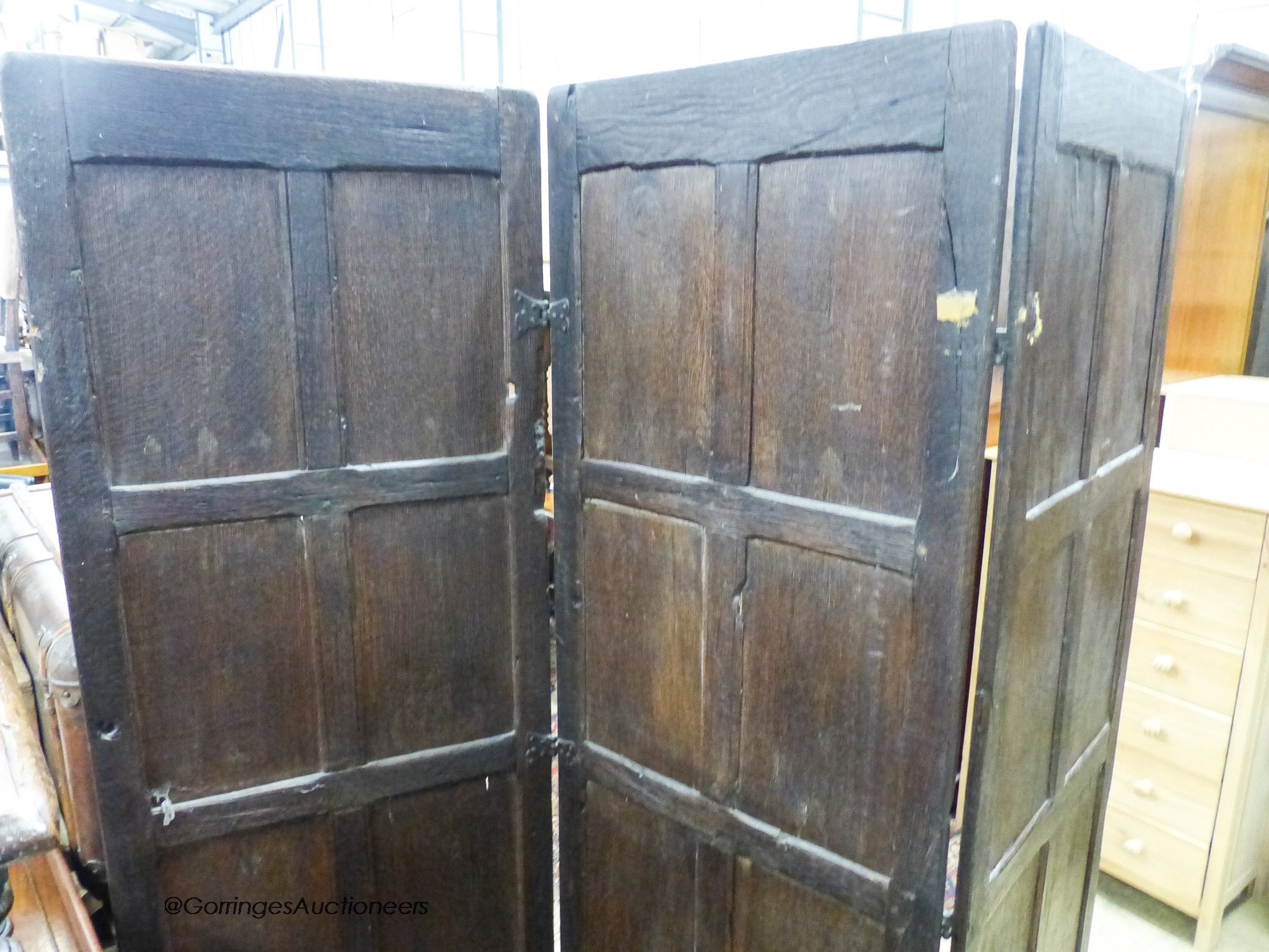 An oak three-fold screen incorporating twenty-four 16th / 17th century linenfold-carved panels, each panel width 59cm, height 182cm